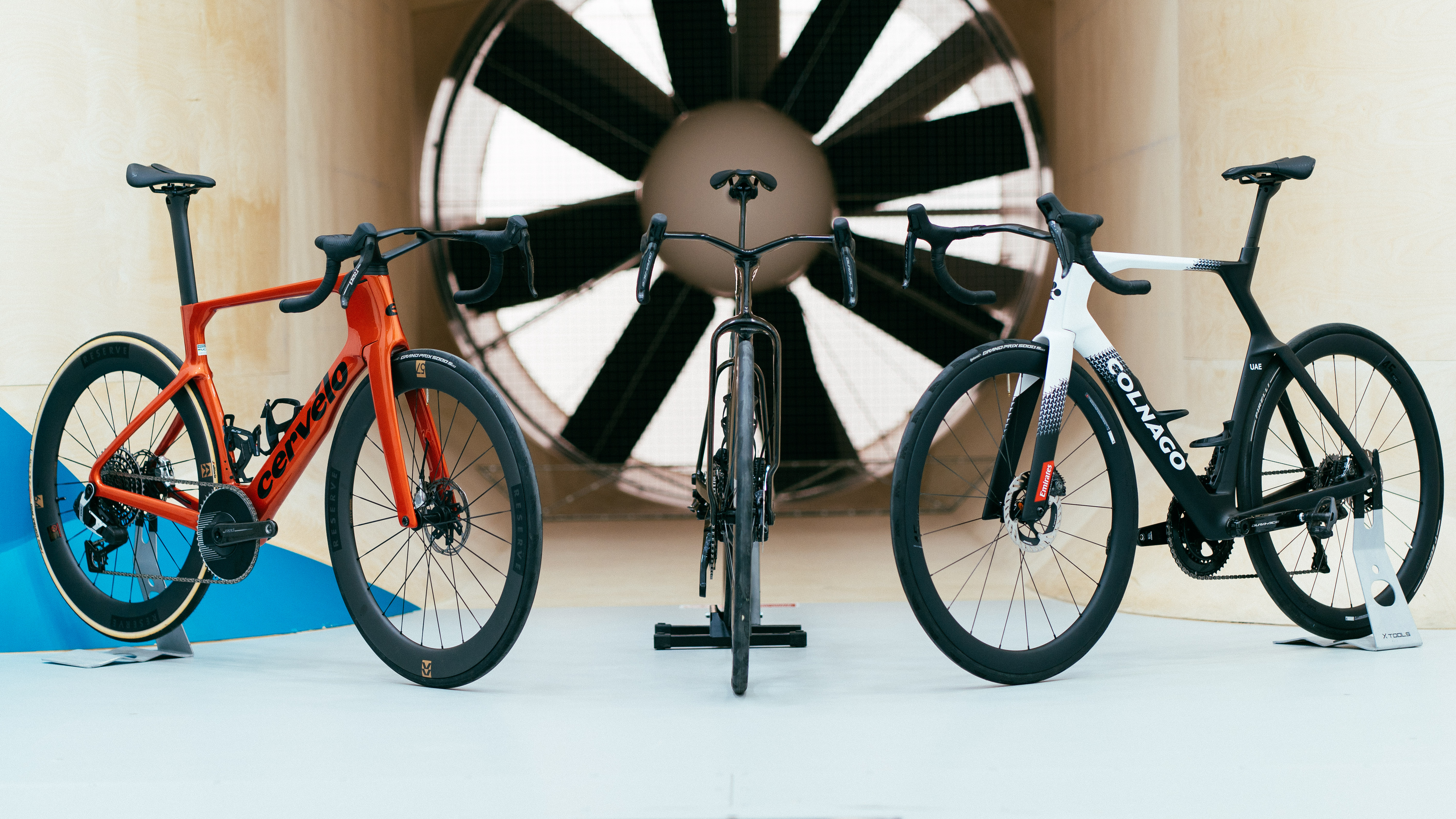 Three aero bikes in front of a giant fan